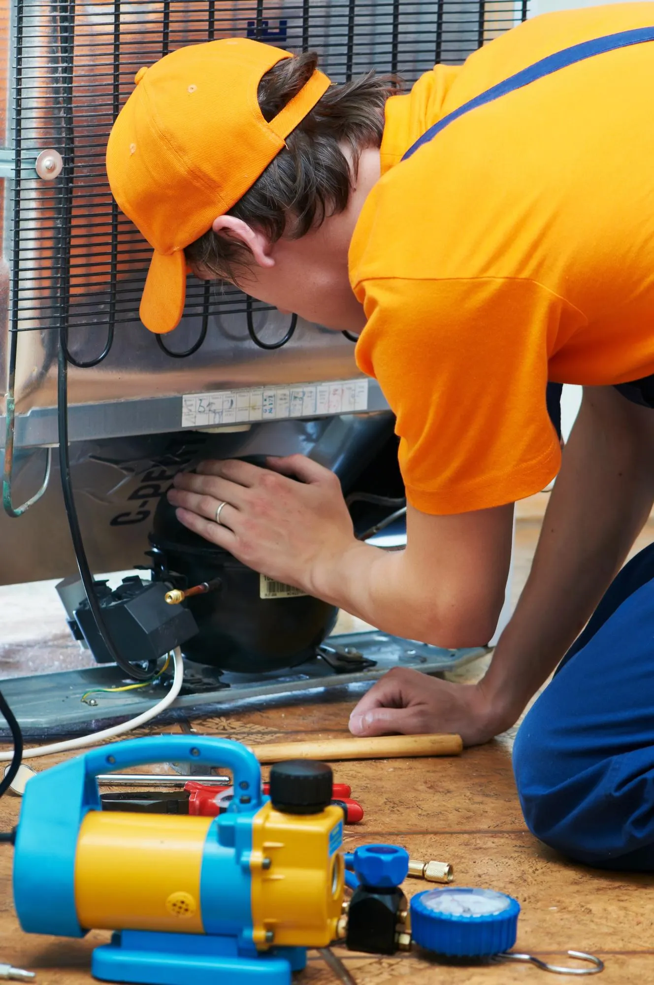 Technician performing appliance troubleshooting